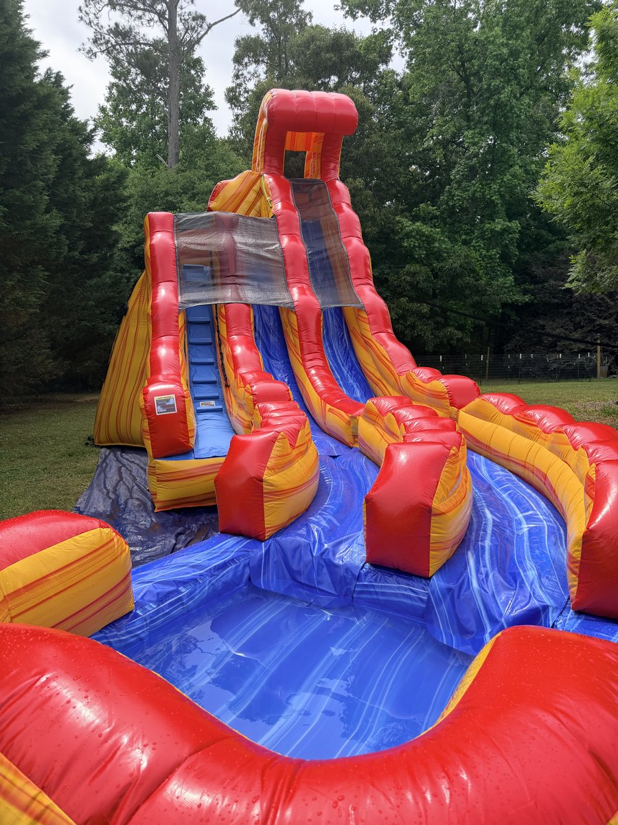 Red and yellow double lane water slide with splash pool